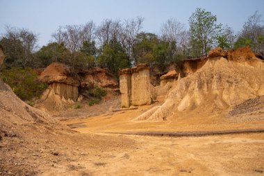 Stunning rock formations at Phae Mueang Phi Forest Park in Phrae, Thailand. A unique geological wonder with rugged sandstone pillars shaped by natural erosion. clipart