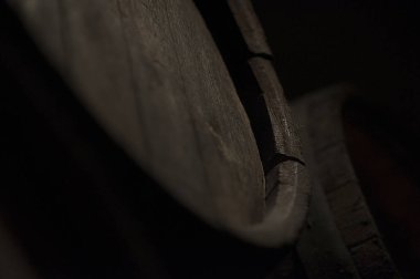 Close-up of a rustic brown wooden oak barrel in Budapest, Hungary. Used for maturing and storing alcoholic beverages like wine and whiskey.