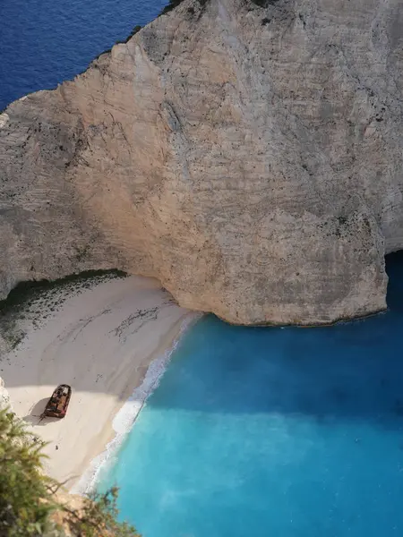Yunanistan 'ın Zakynthos adasındaki Navagio Sahili' nin (Batık Kumsalı) nefes kesici manzarası. Bu dünyaca ünlü koy dik kireçtaşı kayalıkları, canlı turkuaz suları ve beyaz kumların üzerinde duran paslı bir gemi enkazı barındırıyor. Yukarıdan çekilen resim yüksekliği