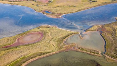 amazing aerial view of blue and pink lakes, sea on horizon. Beautiful natural landscape. Drone shot, bird's eye. Ukraine