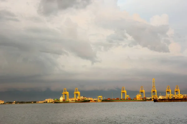 stock image Georgetown, Penang, Malaysia - November 2012: Yellow oil rigs under an cloudy sky above the water off the coast of George Town in Penang.