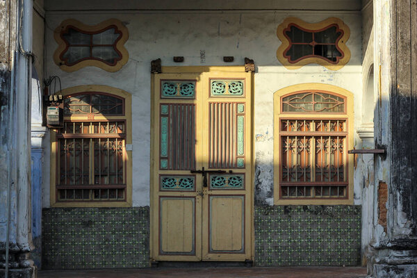 Georgetown, Penang, Malaysia - November 2012: Vintage door and windows with grills of a traditional house in the heritage town of Penang.