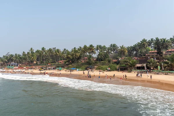 stock image Candolim, Goa, India - January 2023: A view of the crowded beach lined with coconut trees in Sinquerim.