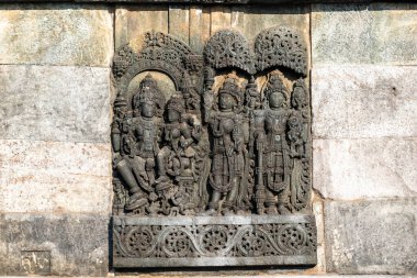 Ornate carvings of a Hindu deities at the ancient Hoysala era Chennakeshava temple in Belur, Karnataka. clipart