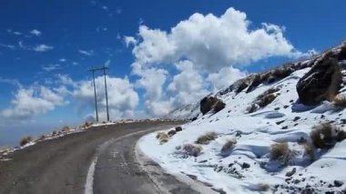 Nevado de Toluca yanardağına tırmanmak için motorsikletle karlı toprak bir yolda seyahat ediyordu.