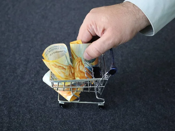 Hand Van Een Man Met Zwitserse Bankbiljetten Een Winkelwagentje — Stockfoto