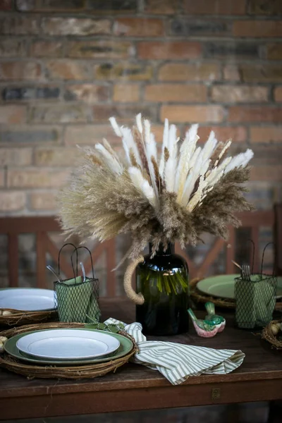 Tuğla duvar zemininde çiçekler ve süslemeler olan masa