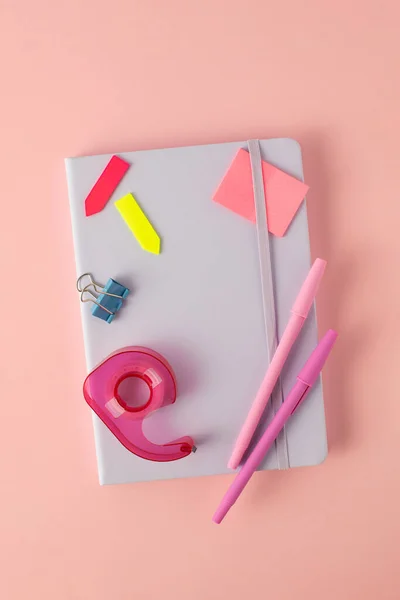 Flat notebook and stylish stationery for school and office on a pink background. Back to School Concept