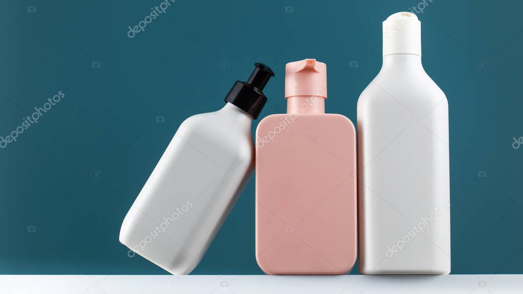 A set of cosmetic bottles on a white shelf with a place for your logo. The concept of routine body skin and hair care, toiletries.