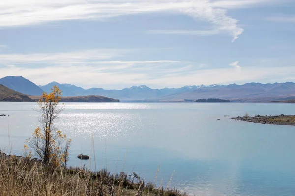 Landscape on lake and mountains. Lake Tekapo in New Zealand in autumn. Travel concept.