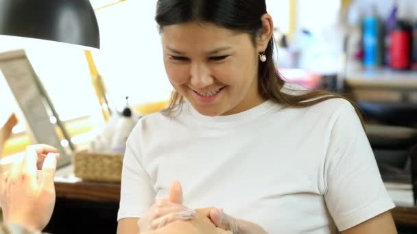 Die Maniküre Meisterin Trägt Eine Feuchtigkeitsspendende Creme Auf Die Hände — Stockvideo