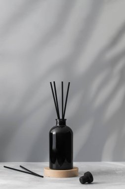 Siyah bir şişedeki bambu çubukları ve ev parfümleri. Ev için güzel kokulu cam ayırıcı. Aromaterapi.