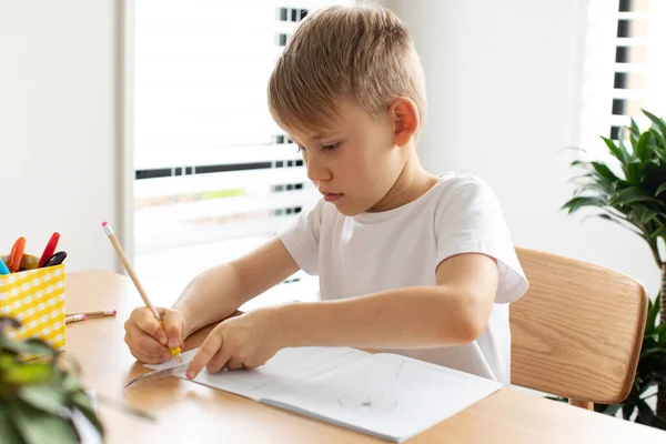 Ένα Χαριτωμένο Αγόρι Ζωγραφίζει Χάρακα Και Μολύβι Έννοια Των Μαθημάτων — Φωτογραφία Αρχείου