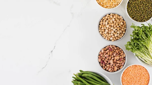 stock image Legumes in glass jars top view. The concept of vegetable protein, vegetarianism, healthy eating. Copy space