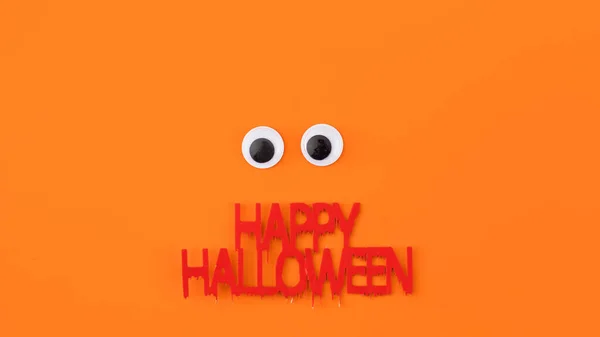 Zabawne Plastikowe Oczy Pomarańczowym Tle Koncepcja Kartki Powitalnej Halloween — Zdjęcie stockowe