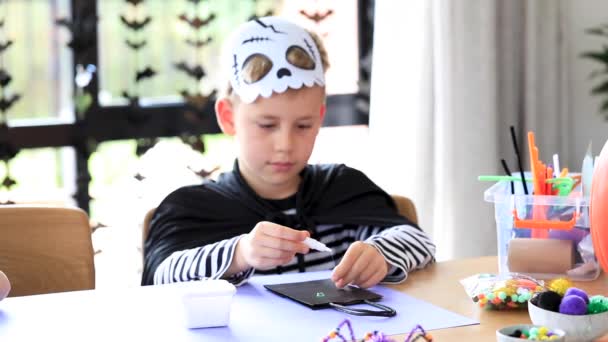 Cute Boy Skeleton Costume Makes Crafts His Own Hands Halloween — Stock Video