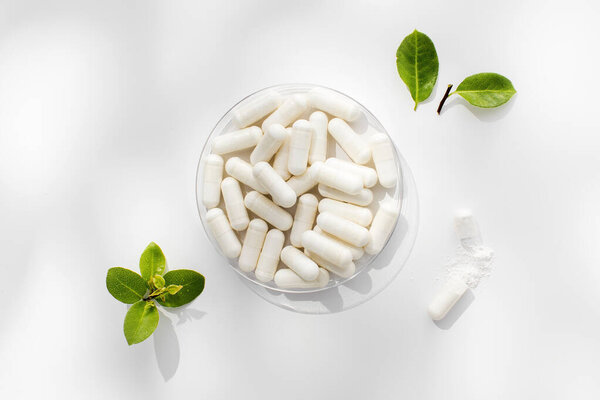 White capsules with minerals or food additives with an organic composition. The concept of pharmaceuticals, medicines, vitamins. 