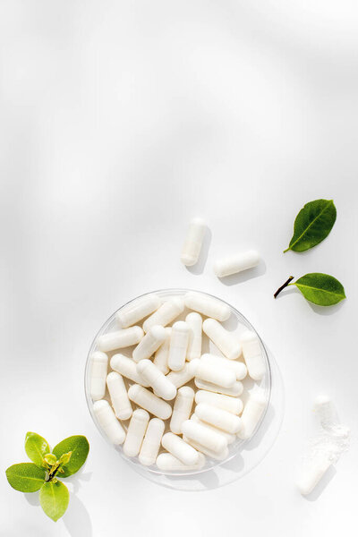 White capsules with minerals or food additives with an organic composition. The concept of pharmaceuticals, medicines, vitamins. Copy space