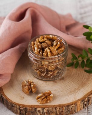 Kırsal bir tahta üzerinde ceviz dolu cam kavanoz sağlıklı bir atıştırmalık için mükemmel. Çatlak.