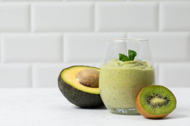 Taze avokado ve temiz yaşam için beyaz arka planda naneli kivi smoothie. Detoks kavramı