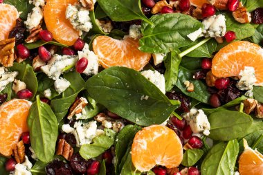 Taze ıspanak ve narlı turunçgil salatası ve sağlıklı yemek için mavi peynir. Vejetaryenler için bayram ve Noel salatası