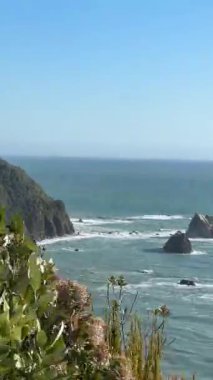 Scenic coastal landscape with waves crashing against rocky shoreline on a clear day. West Coast, New Zealand. Concept of travel 