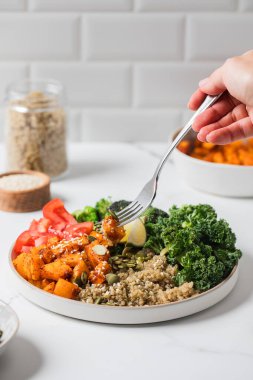 Healthy vegan buddha bowl with quinoa, kale, and roasted vegetables for nutrition and wellness. Healthy food
