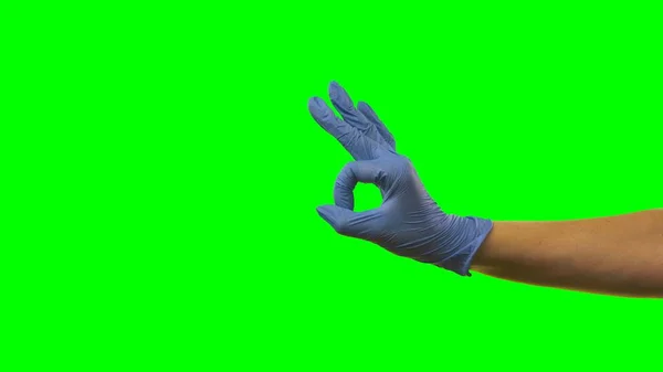 Mão Mulher Uma Luva Azul Médica Mostrando Gesto Sinal Braço — Fotografia de Stock