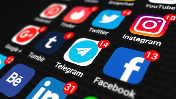 Stock image Editorial shot: popular icons of social media apps with numbers on notification counter on black screen smartphone. Mobile app of social network with signs Instagram, Twitter, Facebook, linkedin