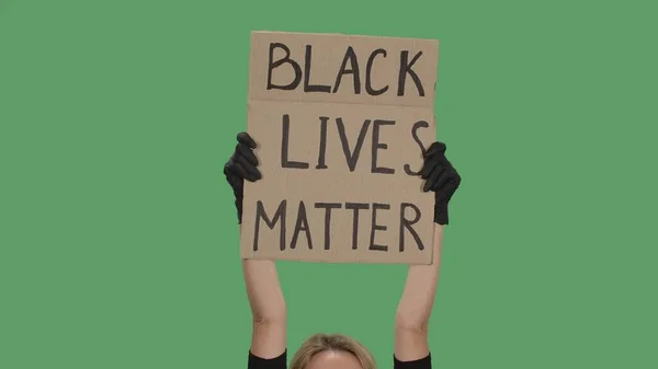 Handen Van Een Onbekende Persoon Zwarte Handschoenen Verhogen Kartonnen Affiche — Stockfoto