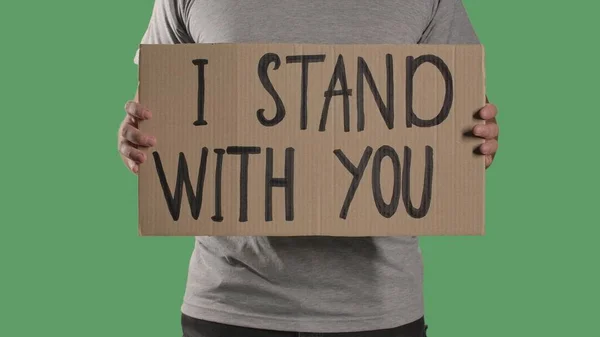 Man Holds Front Him Poster Cardboard Box Words Stand You — Stock Photo, Image