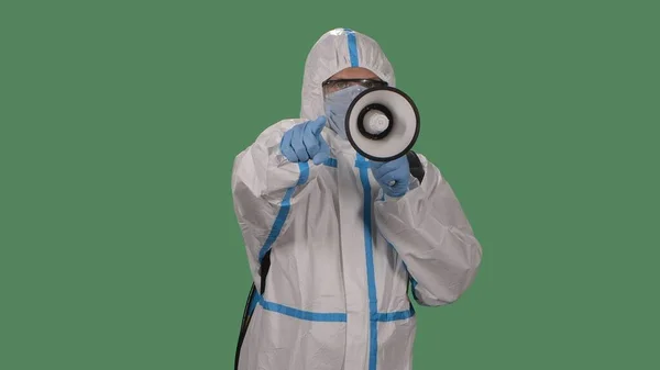 Man White Protective Suit Glasses Gloves Medical Mask Speaks Megaphone — Stock Photo, Image