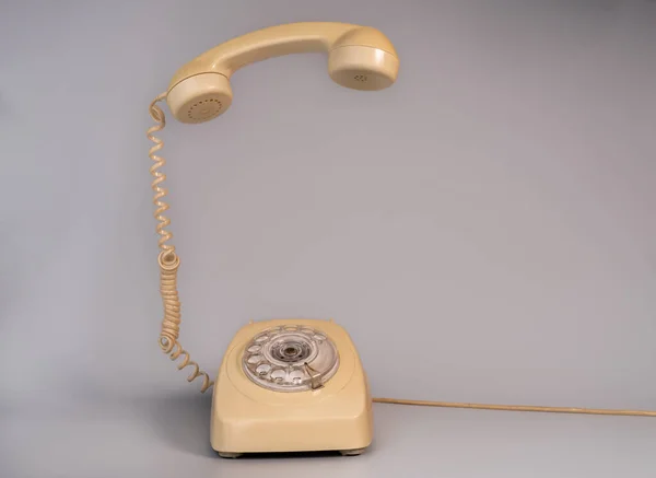Old Beige Aged Rotary Telephone Removed Hanging Receiver Grey Background — Stock Photo, Image