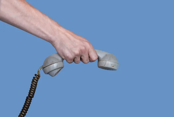 Male Hand Holding Old Gray Plastic Telephone Receiver Blue Background — Stock Photo, Image