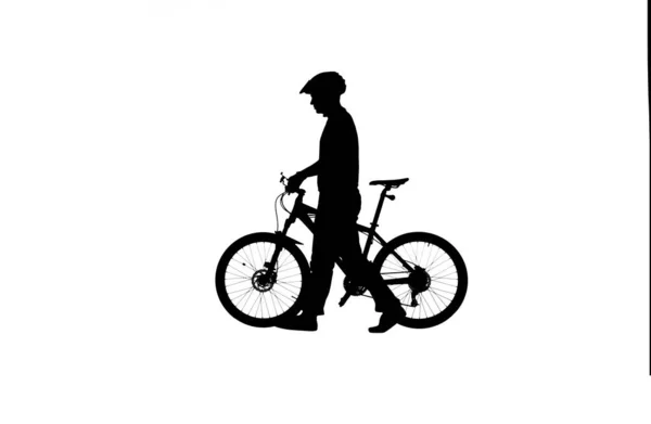 白い背景に自転車のヘルメットでサイクリストの黒いシルエットのサイドビュー 自転車で歩く男性の自転車乗り アクティブスポーティな人のコンセプトイメージ — ストック写真