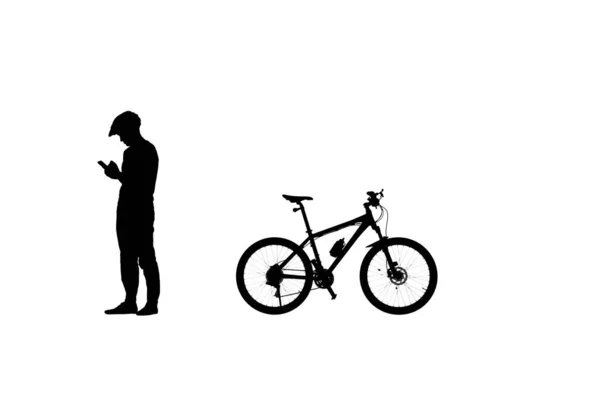 彼のスマートフォン上のサイクリストテキストの黒のシルエットのサイドビュー スポーツウェアを着た男性自転車愛好家と白い背景の自転車ヘルメット トレーニング アクティブな休息 アクティブなスポーティーな人々 — ストック写真