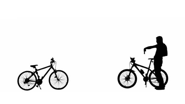 白い背景に男性サイクリストの黒いシルエットが軽やかに踊り 手の動きを披露します 2台のスポーツモダンな自転車の近くに完全に長さに立つ陽気な幸せな男 アクティブなスポーティーな人々 — ストック動画