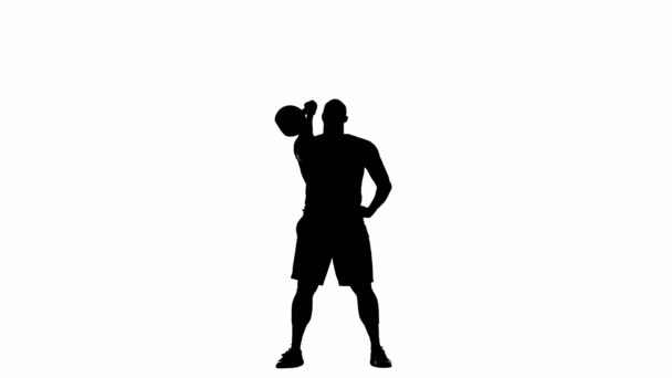 ハンドル付きの大きな重いケトルベルを持ち上げる筋肉の男の黒いシルエット 腹部の筋肉のための練習をするボディビルダー 強みの訓練 パワーリフティング又はクロスフィット — ストック動画