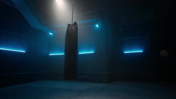 Long Black Punchbag Hanging Swinging Chain Dark Empty Gym Blue — Wideo stockowe