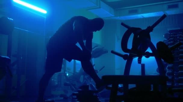 Dark Silhouette Muscular Man Bandaging His Knees Sports Bandages Athlete — Stok video