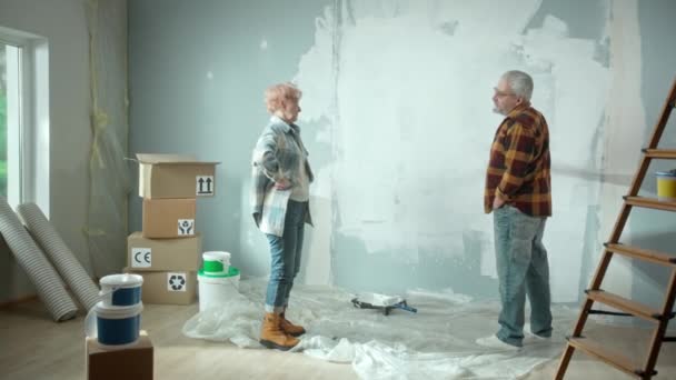 Elderly Man Painting Wall White Paint Using Paint Roller Older — Stockvideo