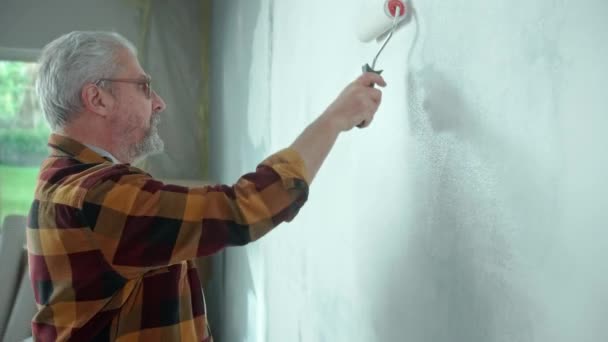 Elderly Man Painting Wall White Paint Using Paint Roller Male — Stockvideo