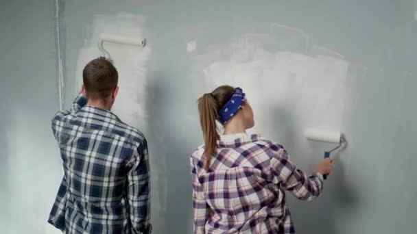 Young Man Woman Painting Wall White Paint Using Paint Rollers — 图库视频影像