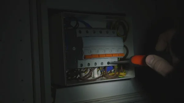 Electrician Assembles Electrical Panel Dark Light Flashlight Close Man Hands — Zdjęcie stockowe