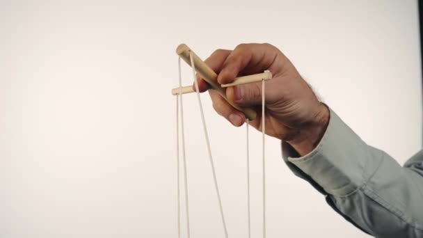 Hand Man Gray Shirt Controls Puppet Using Wooden Manipulator Strings — Vídeo de stock