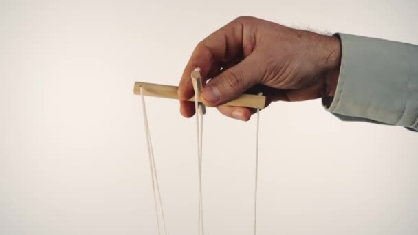 Hand Man Gray Shirt Controls Puppet Using Wooden Manipulator Strings — Stockvideo