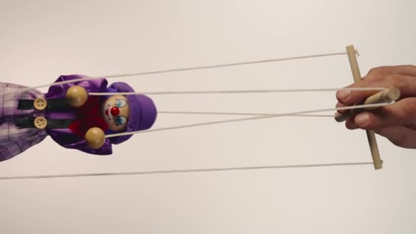 Hand Man Controls Clown Marionette Hanging Strings Rag Doll Purple — Stok Video