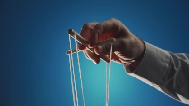 Hand Man Gray Shirt Controls Puppet Using Wooden Manipulator Strings — Vídeos de Stock