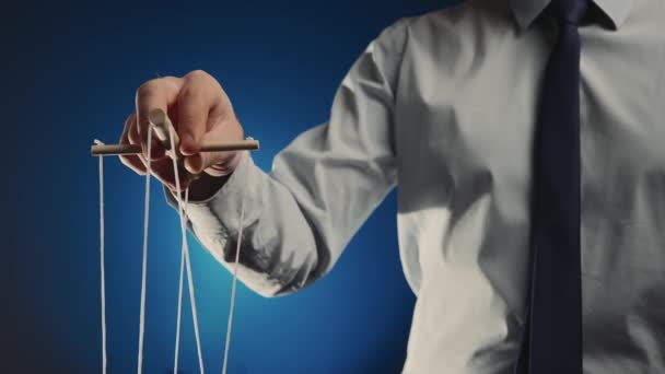Businessman Gray Shirt Black Tie Controls Puppet Wooden Manipulator Strings — Vídeo de Stock