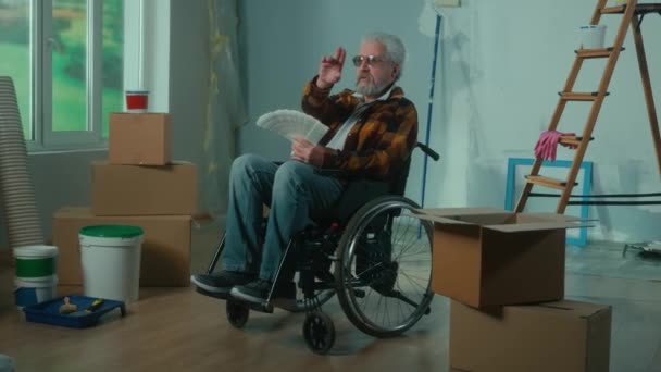 Elderly Disabled Man Moves Wheelchair Looks Palette Colors Pensioner Plans — Videoclip de stoc